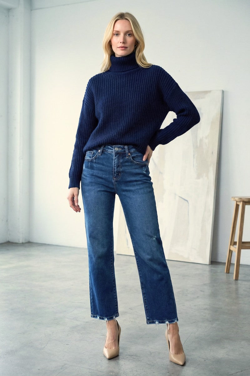 Woman wearing dark stone wash high rise straight leg jeans with frayed hem and tummy control lining, Rosie Karma boutique