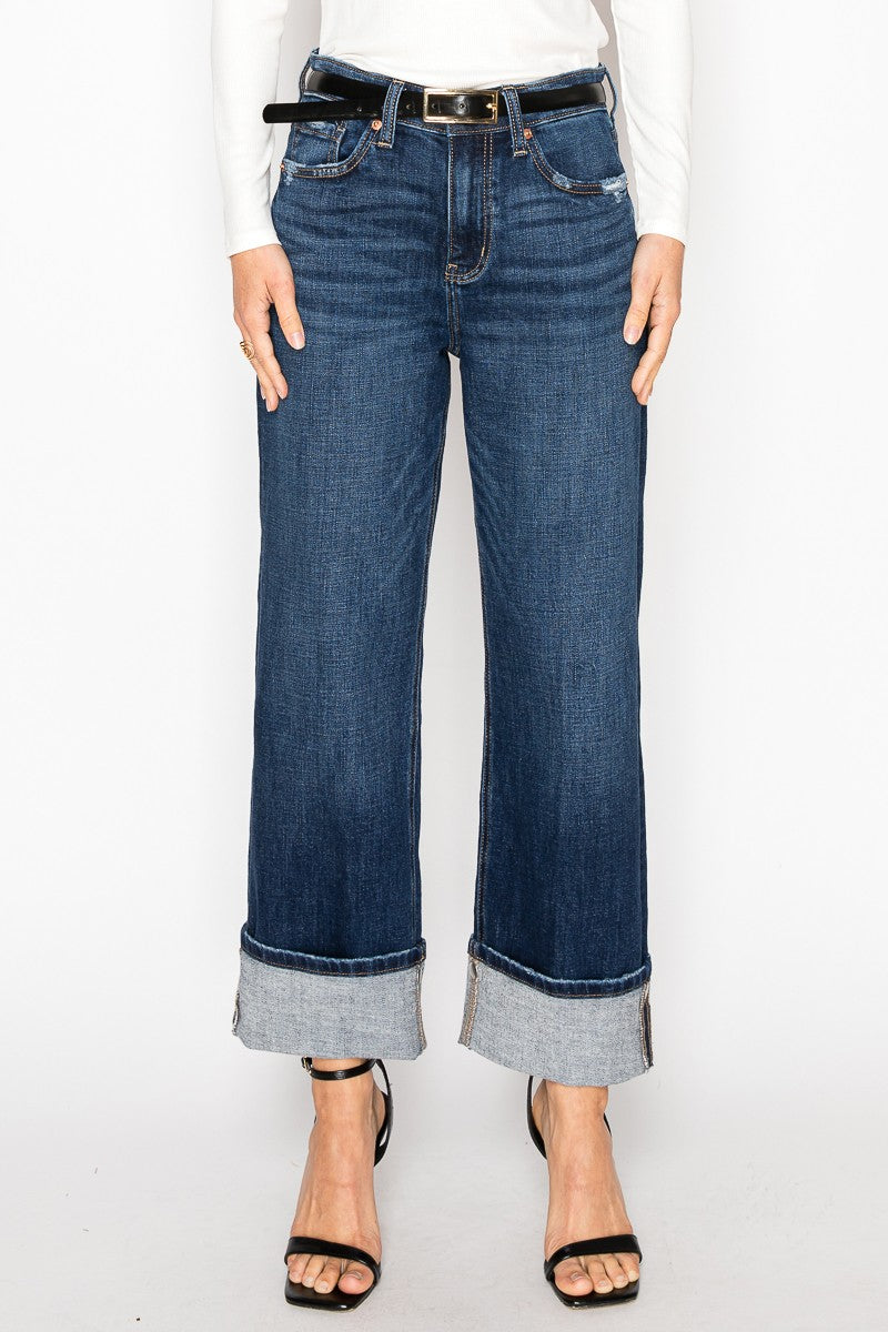 Woman wearing the Noelle dark stone wash high rise relaxed straight jeans with cuffed ankle hem, Rosie Karma boutique