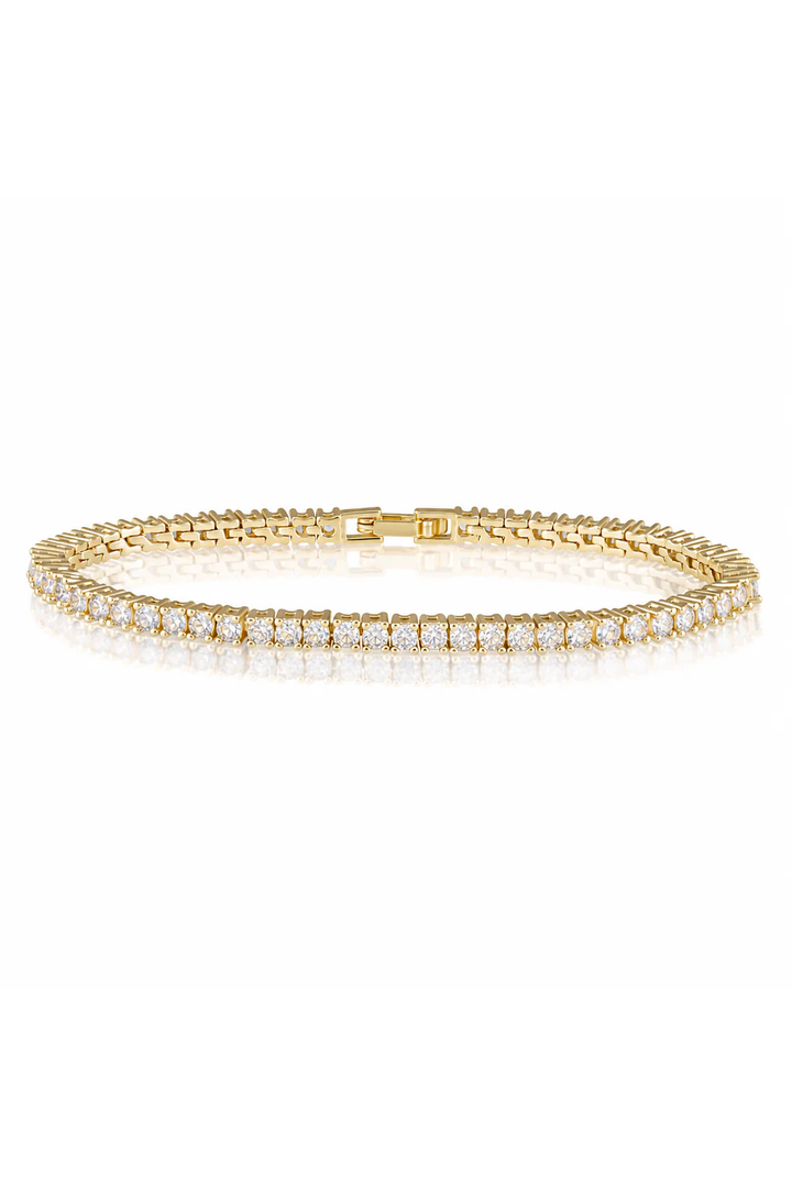 Gold bracelet with cz stones on a white background