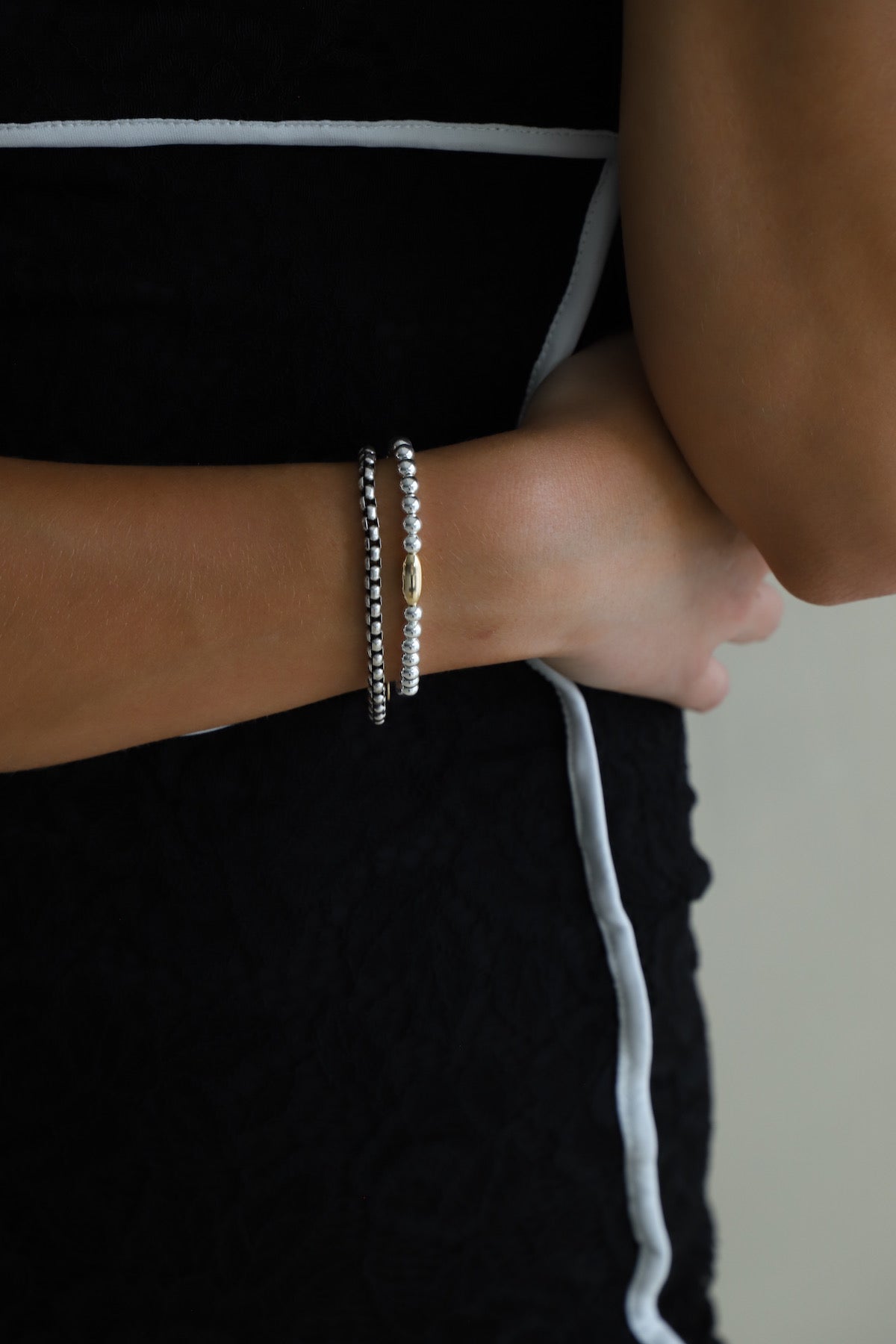 Nova Chain two-tone bracelet with a silver chain and gold clasp. Stacked with another bracelet