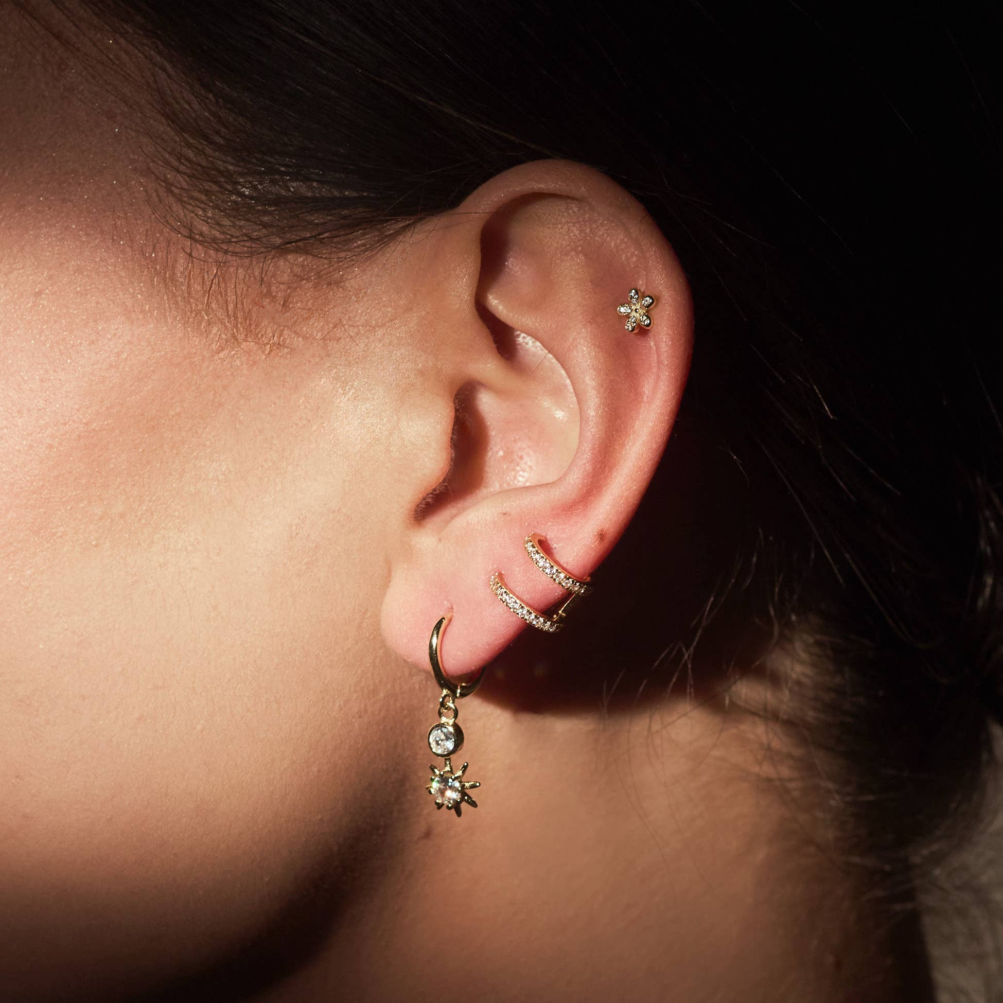 Close-up of a persons ears wearing FYB Delaney Huggie Earrings