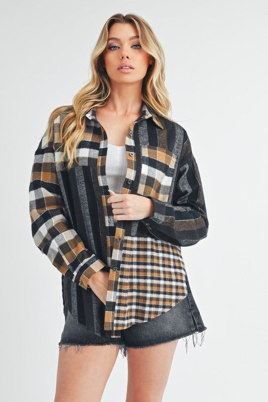 A woman with blonde hair wearing the Lena multi-plaid flannel shirt, styled open over a white t-shirt and dark wash jeans shorts