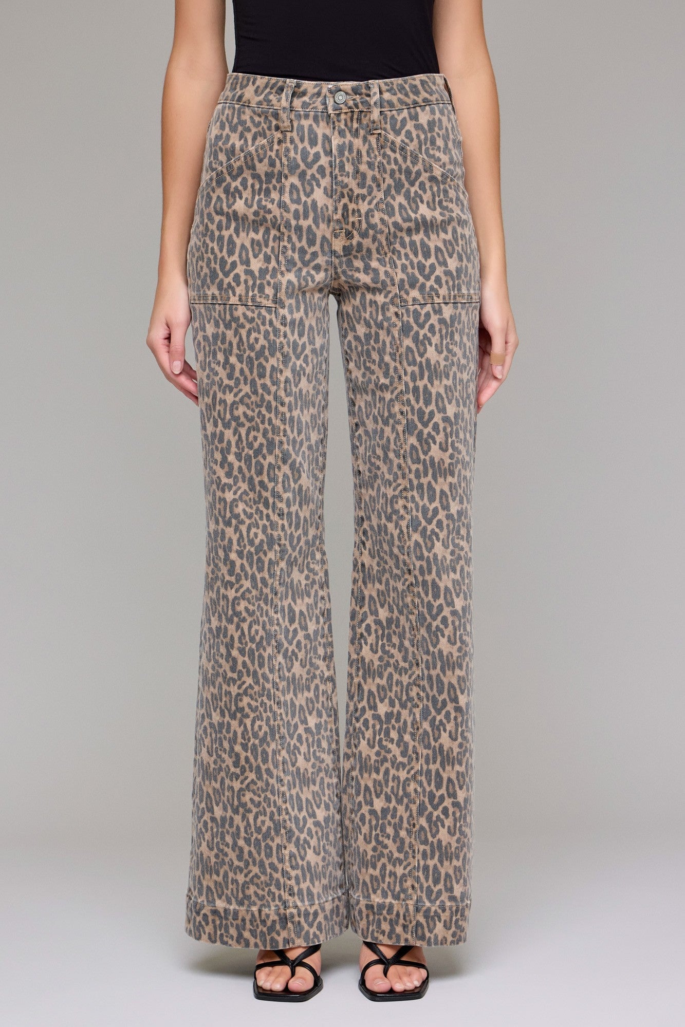 Leopard print pants worn by a person on a plain background