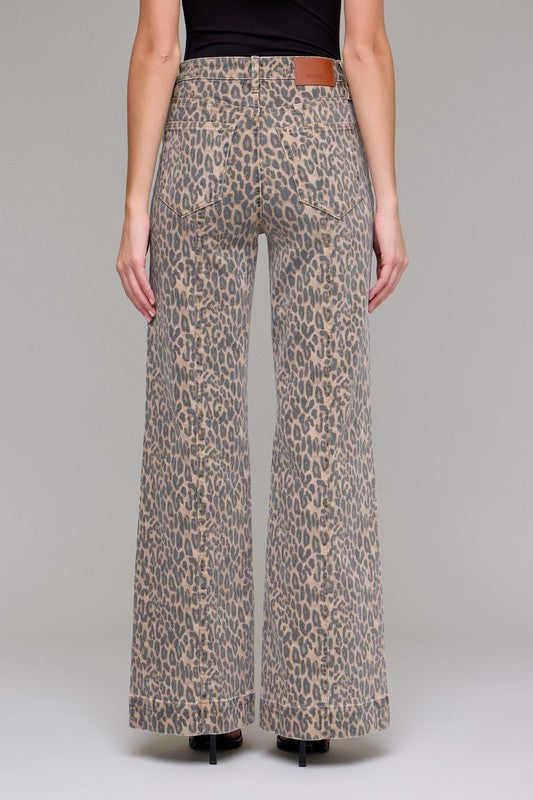 Leopard print pants worn by a person on a plain background