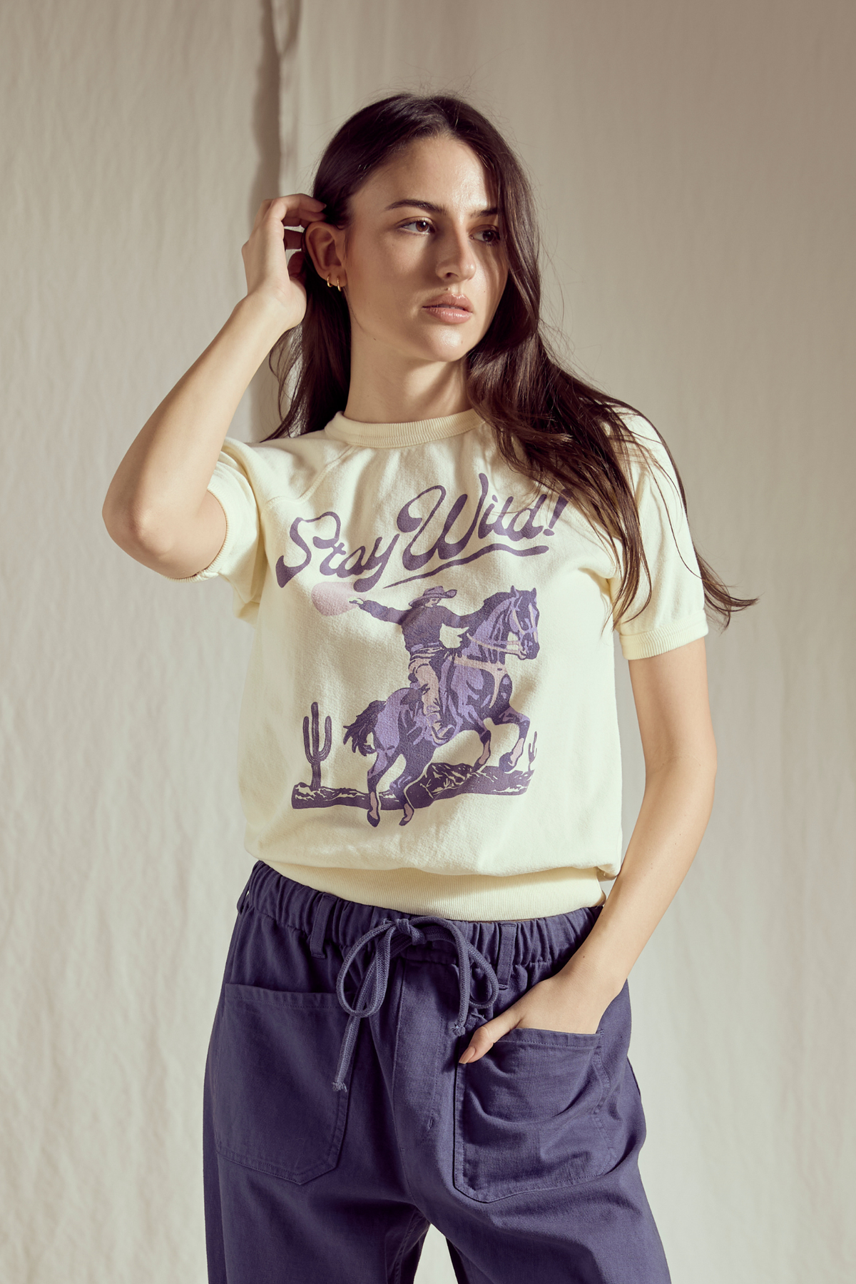 People of Leisure Stay Wild Raglan Tee — vanilla western graphic raglan tee with a playful “Stay Wild” cowgirl design.