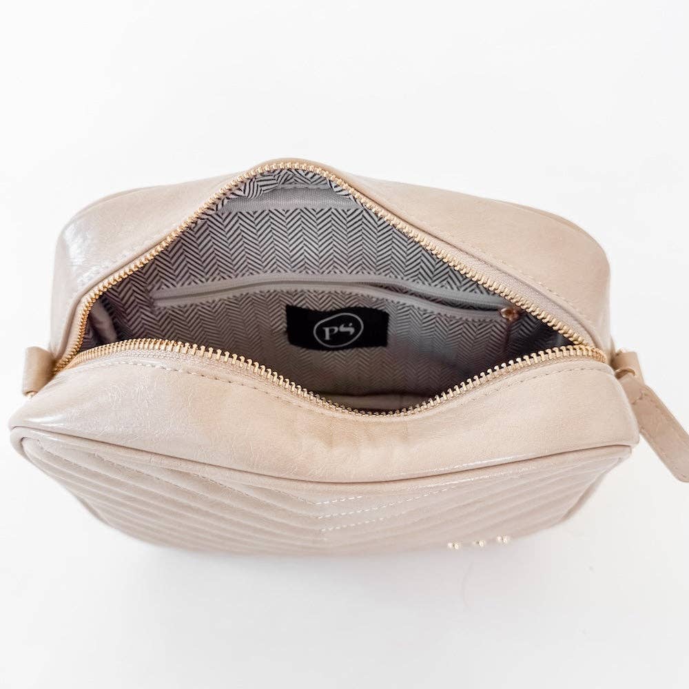 Beige handbag with a visible brand logo on a white background