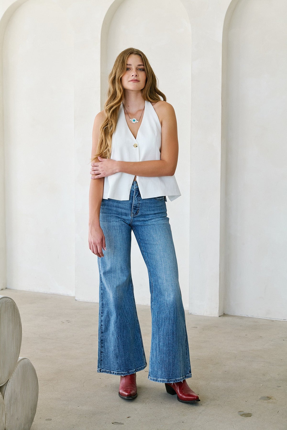 Woman wearing medium stone wash high rise palazzo jeans with tummy control waistband, Rosie Karma boutique