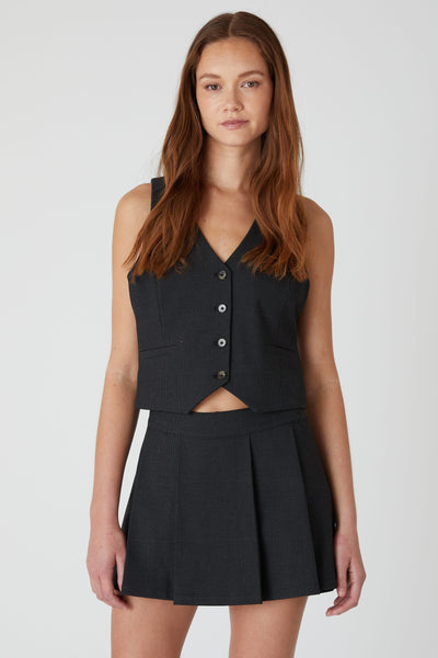 Effortless plaid vest outfit – styled with a black pleated skirt