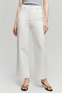 Person wearing white pants on a plain background