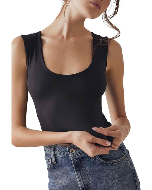 Woman standing in flattering black scoop neck tank top Free People styled with jeans