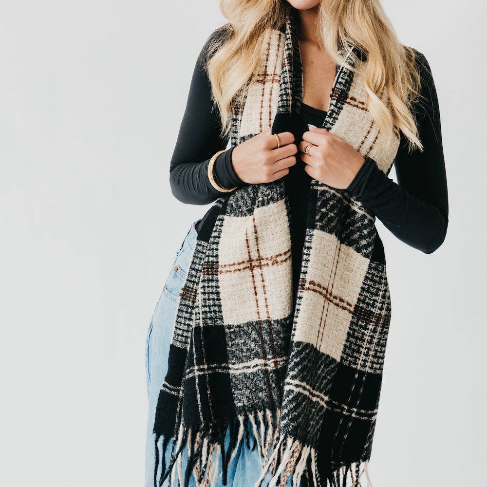Person wearing a plaid scarf with a plain background