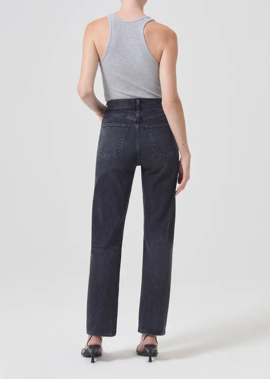 Back view of the Agolde Stovepipe jeans in "Metal," showing the washed-down black denim texture
