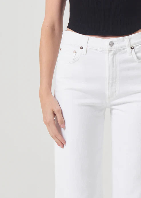 A close-up shot of the Agolde Harper Crop jeans in a clean white wash