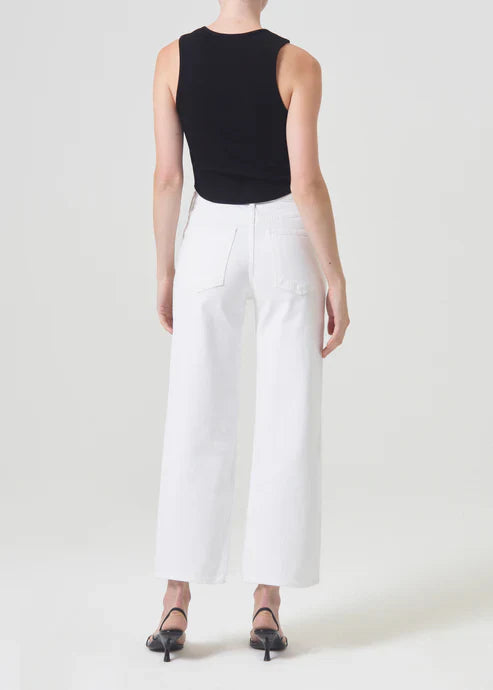 Back view of model wearing Agolde Harper Crop jeans in "Sour Cream," a pair of white, mid-rise jeans with a relaxed, cropped wide-leg fit.