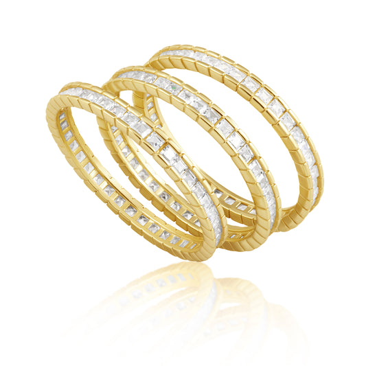 Gold and diamond stack of three rings with cz's all the way around on a white background