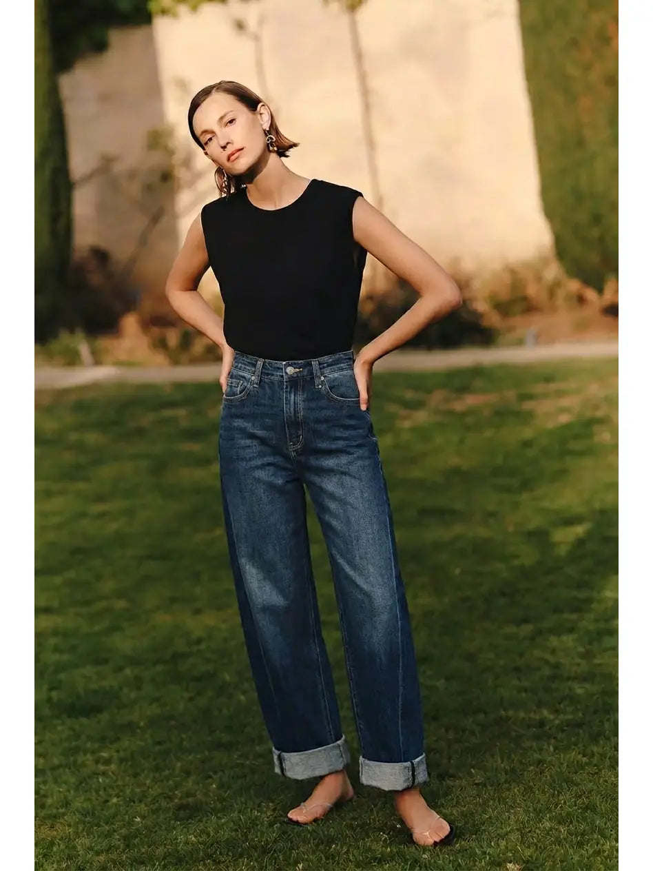 Woman wearing the Artemis Vintage Cleo dark wash high rise barrel jeans with tapered cuffed ankle, Rosie Karma boutique