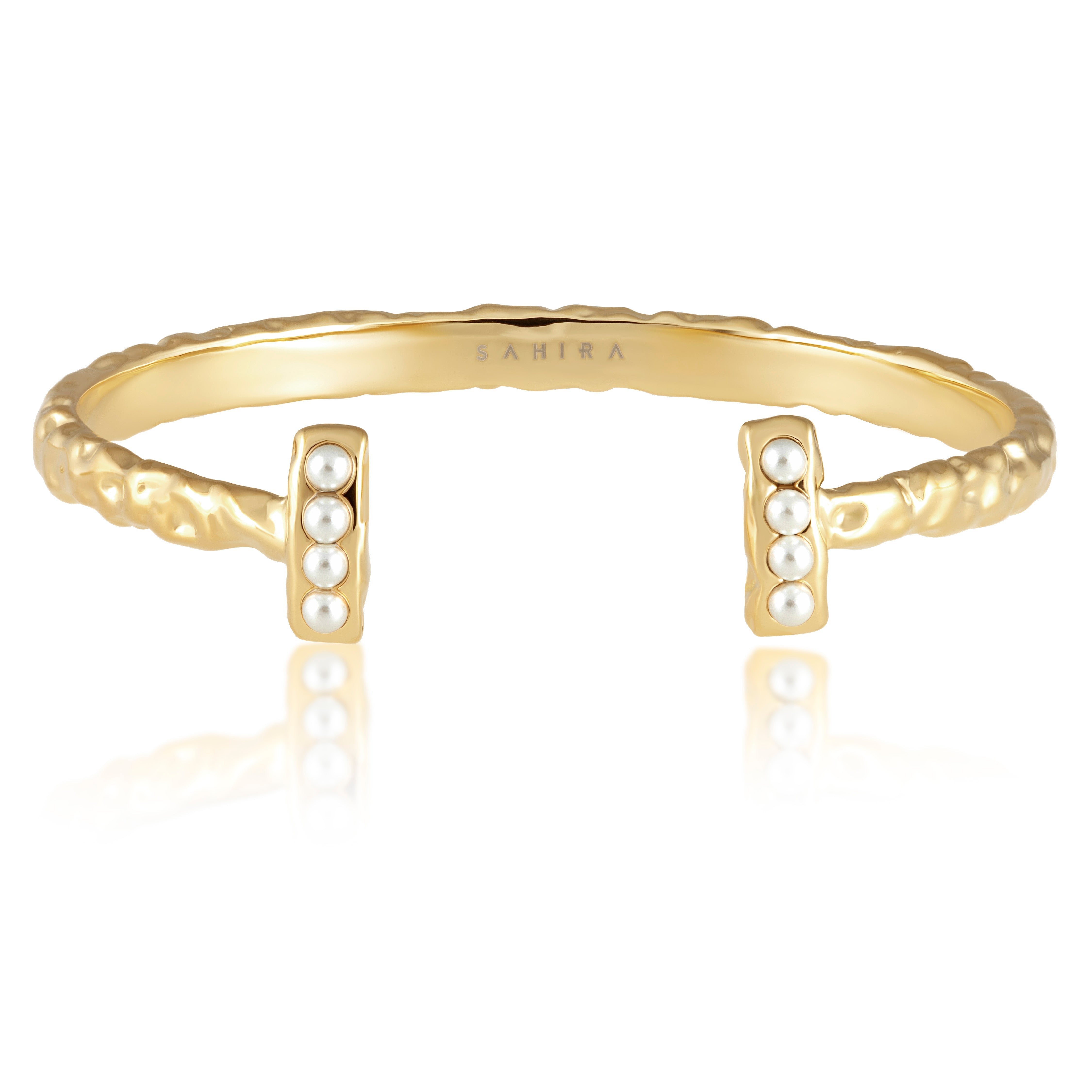 Gold bracelet with pearl accents on a white background