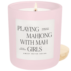 Pink candle with a label reading 'Playing Mahjong with Mah Girls' on a green background