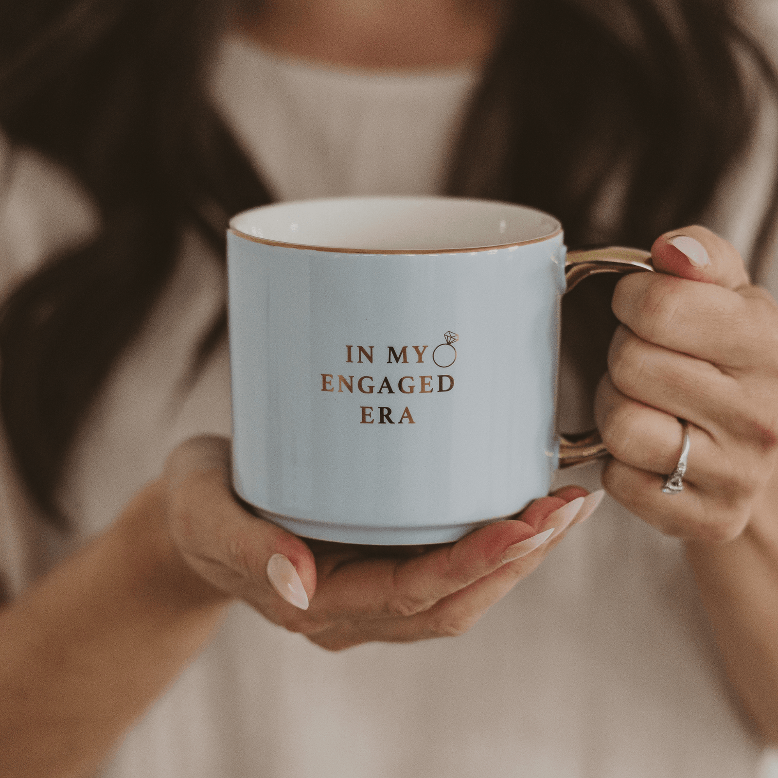 Person holding a mug with 'In my engaged era' text