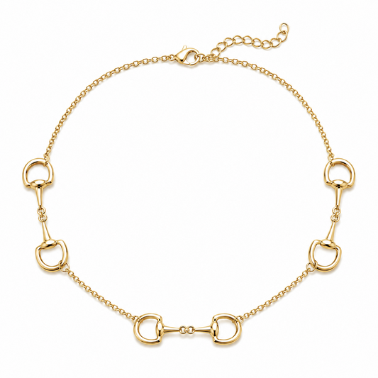 A gold horsebit chain necklace featuring five horsebit links spaced evenly along a delicate cable chain, with a lobster clasp closure at the top, shown on a plain white background.