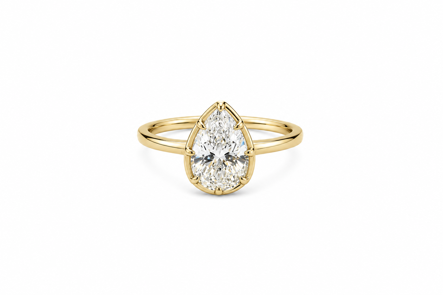 Gold ring with a pear-shaped diamond on a white background