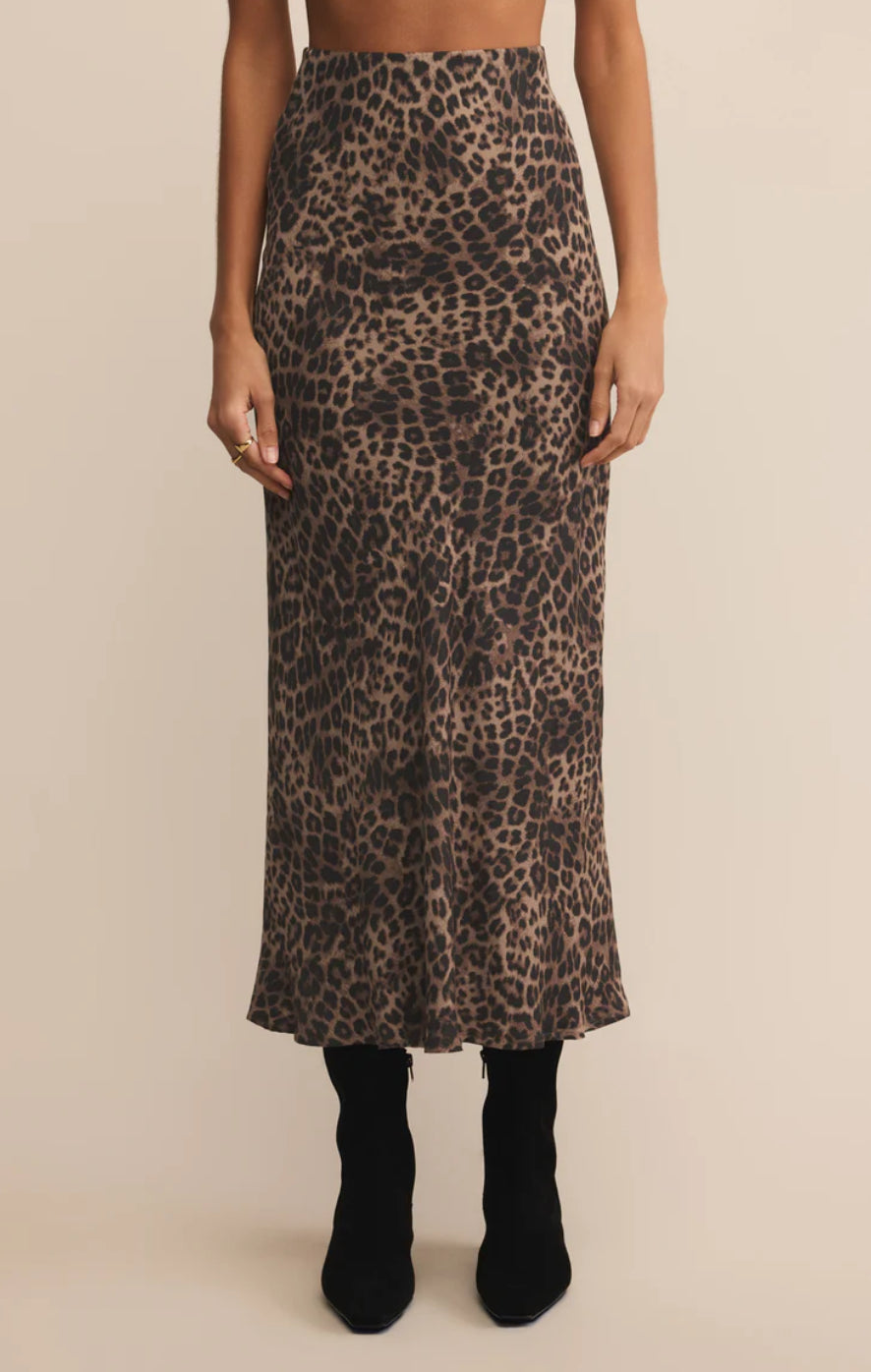 Leopard print skirt worn by a person on a beige background