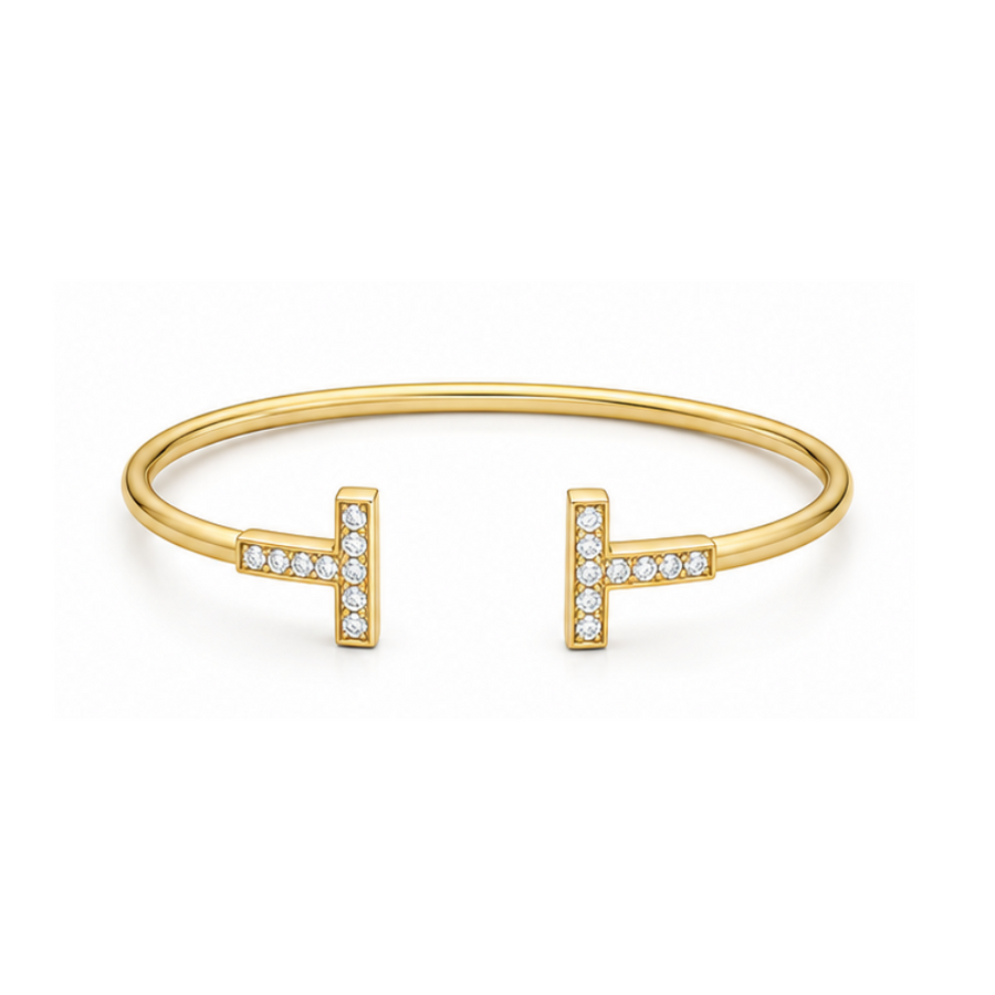 Gold bracelet with 'H' and diamond accents on a white background