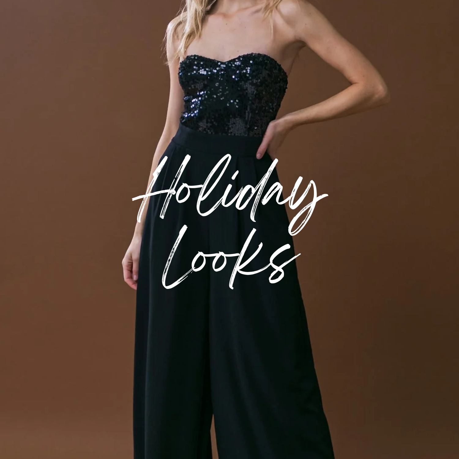 Woman wearing a purple free people jamie henley long-sleeve top and brown pants against a plain background