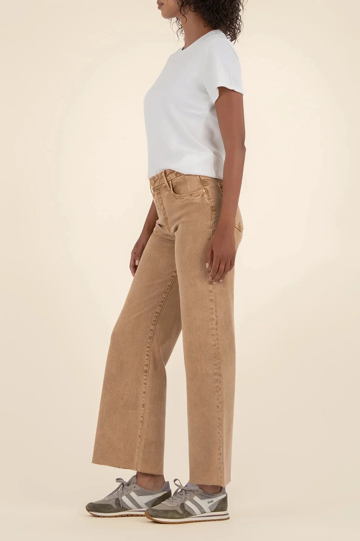 Person wearing a white t-shirt and Meg tan high-rise wide-leg jeans on a beige background