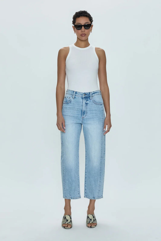 Pistola Eli High Rise Arched Leg jeans in "Sun Kissed," a pair of light blue denim jeans with a high waist, relaxed bowed leg, and slimming fade details.