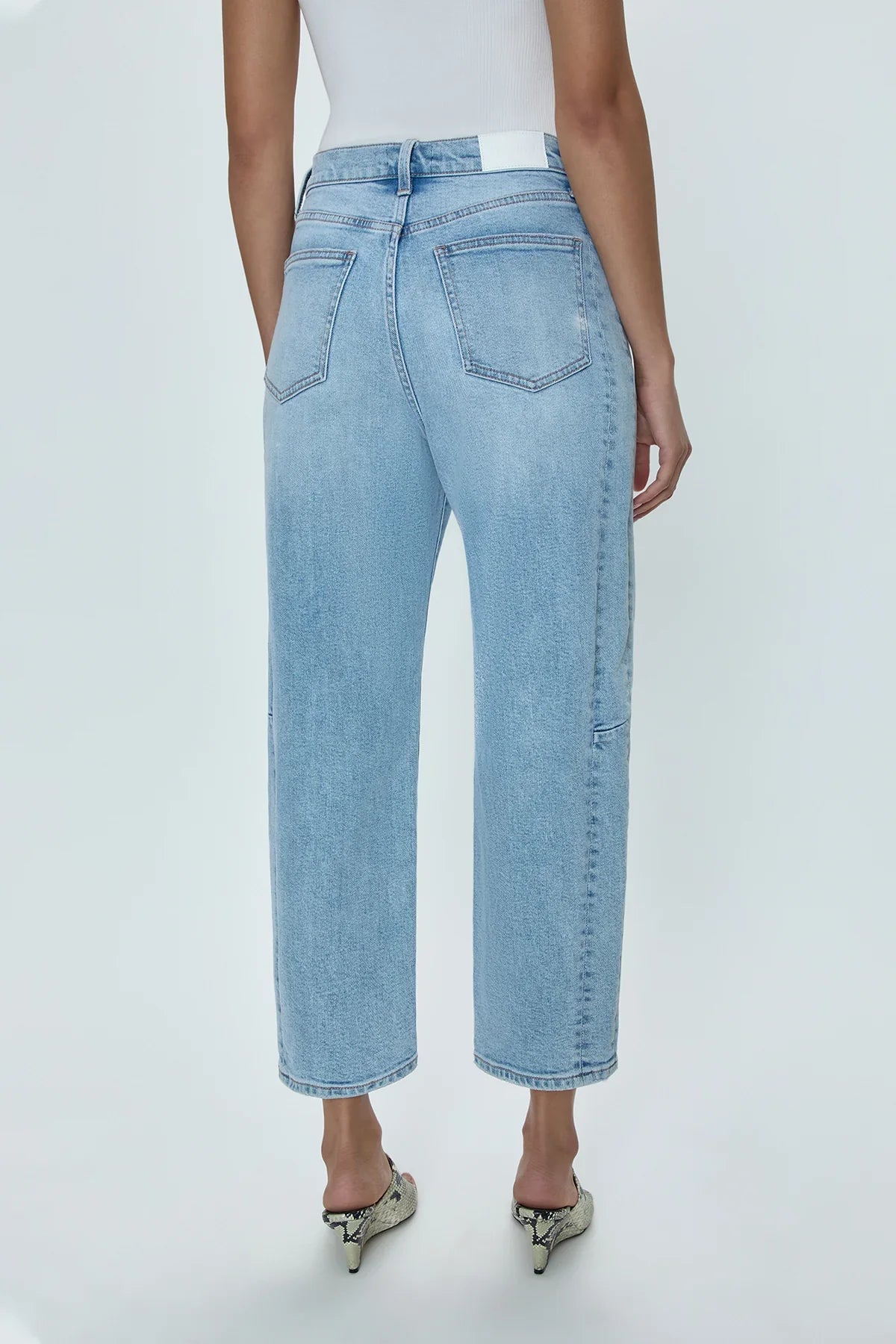 Light blue jeans worn by a person on a white background