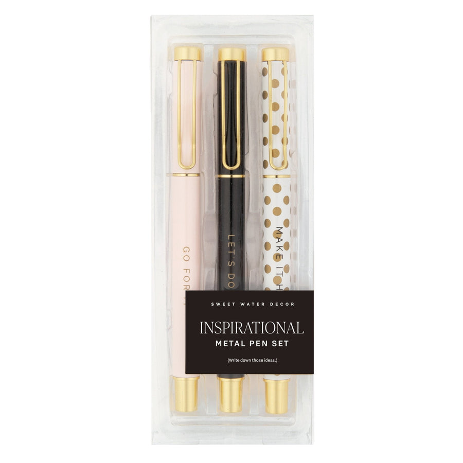 Set of three metal pens in packaging with decorative designs and text.