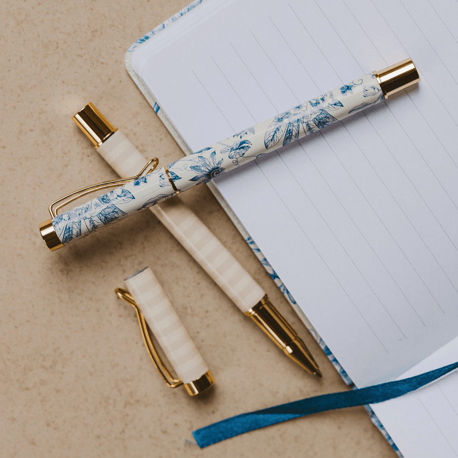 Decorative pen with floral pattern on a notebook