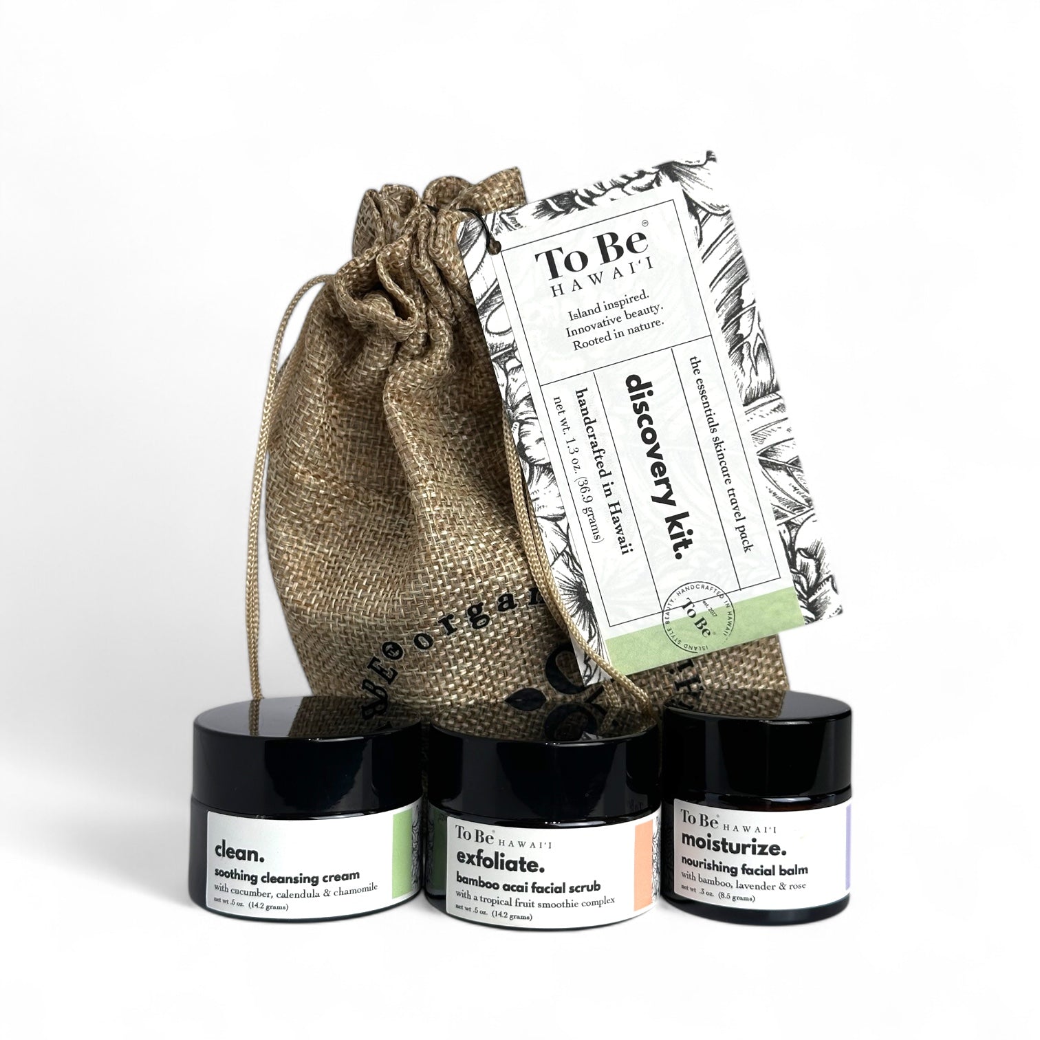 Skincare discovery kit with three jars and a drawstring bag on a white background