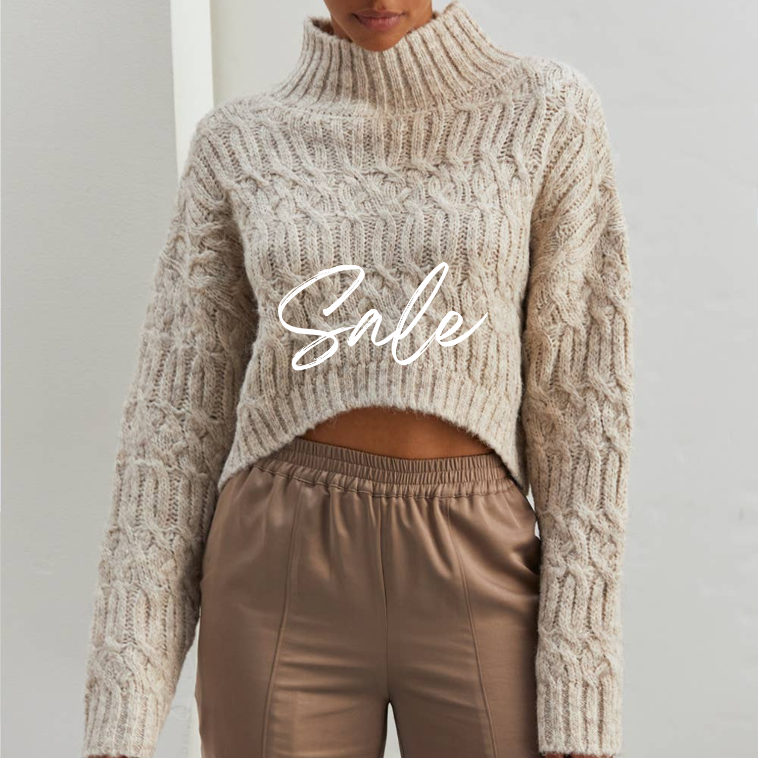 A woman wearing a short sleeve, knee-length brown chiffon dress with a round neckline and ruffle detailing.