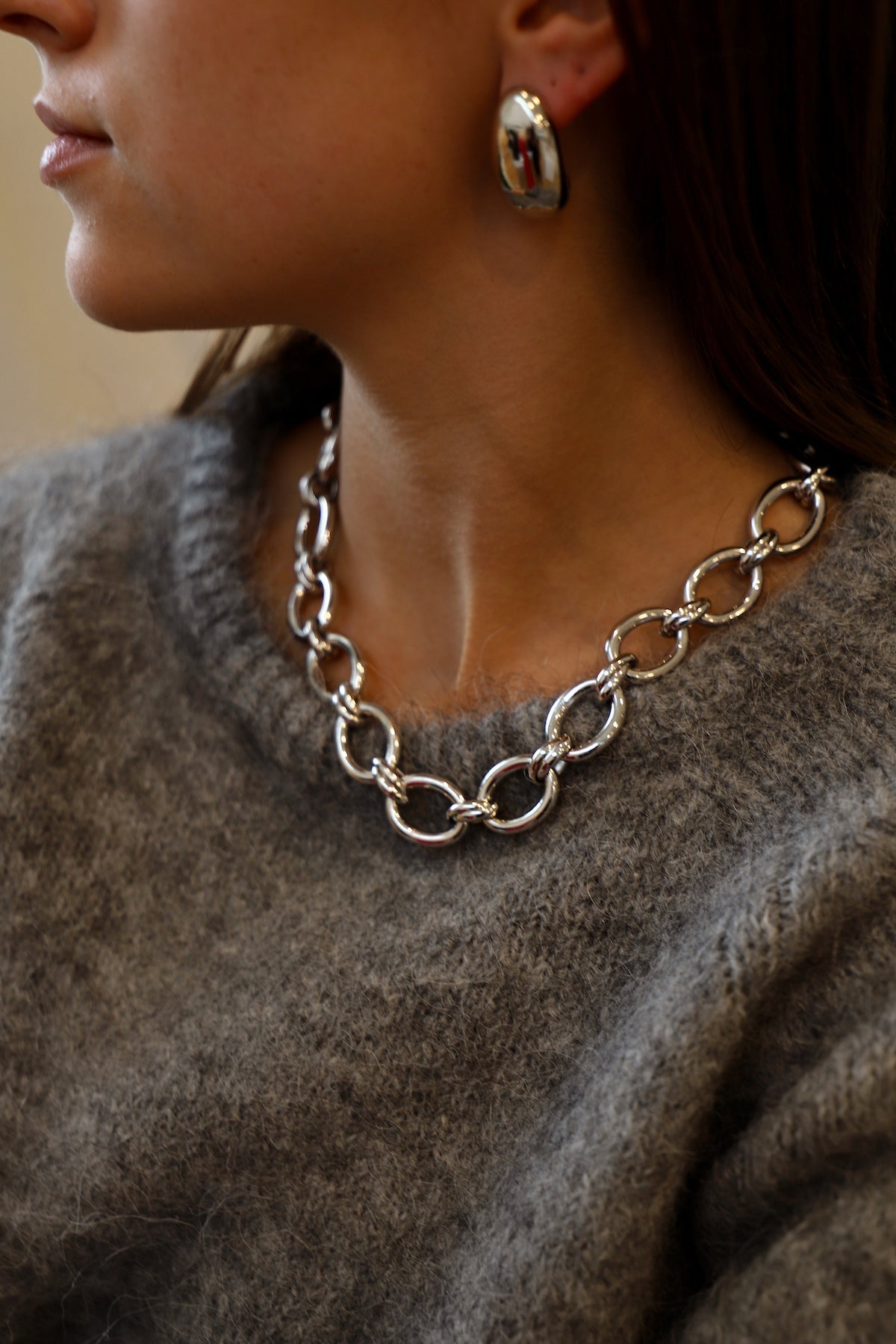 Close up of a person wearing an elegant thick chain necklace 
