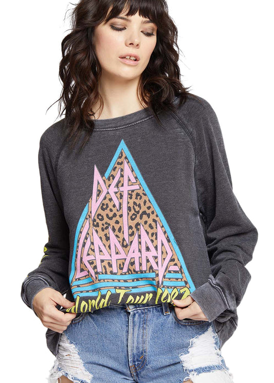 Woman wearing a dark gray sweatshirt with a colorful graphic design on a white background