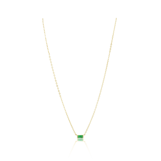 Gold necklace with a green gemstone pendant on a white background