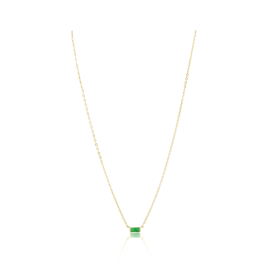 Gold necklace with a green gemstone pendant on a white background