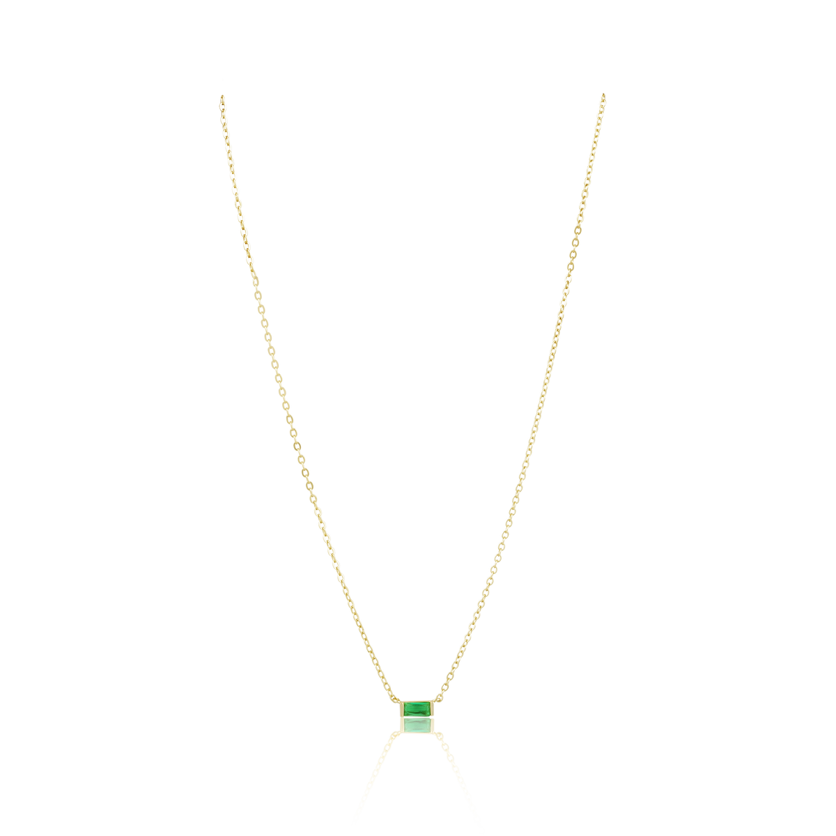 Gold necklace with a green gemstone pendant on a white background