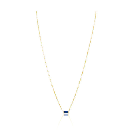 Gold necklace with a square pendant on a white background