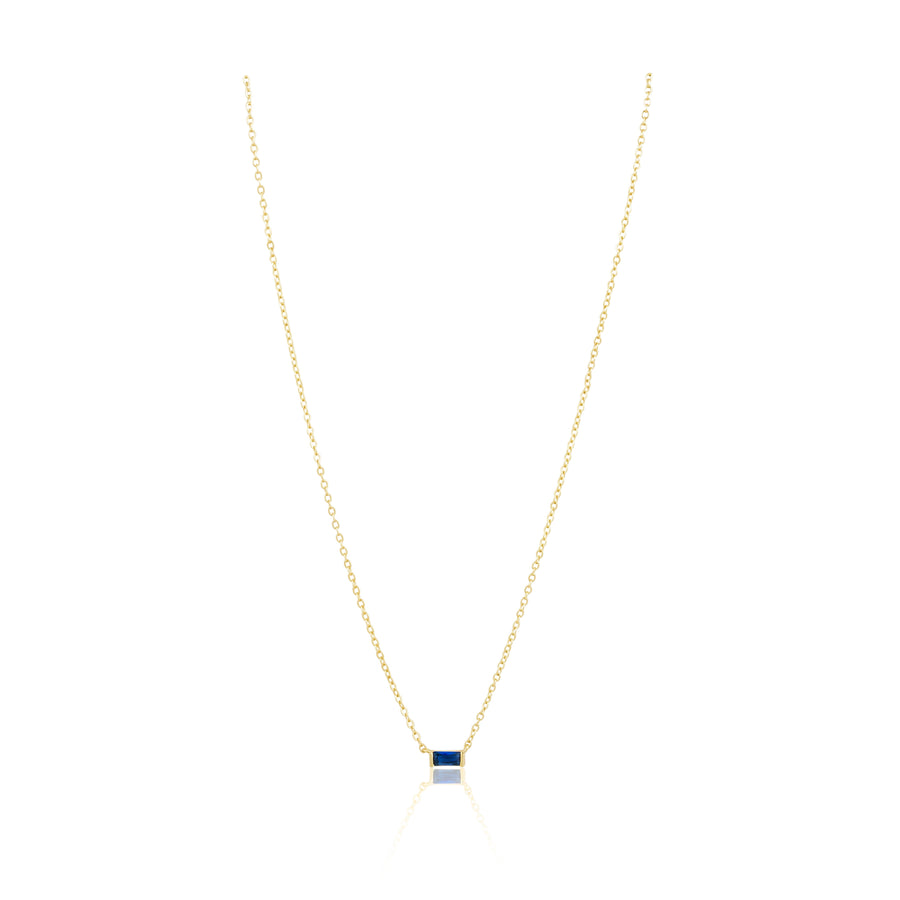 Gold necklace with a square pendant on a white background