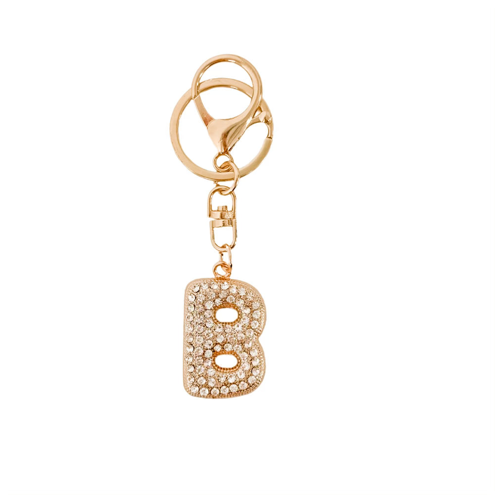 Gold keychain with letter 'B' charm on a white background