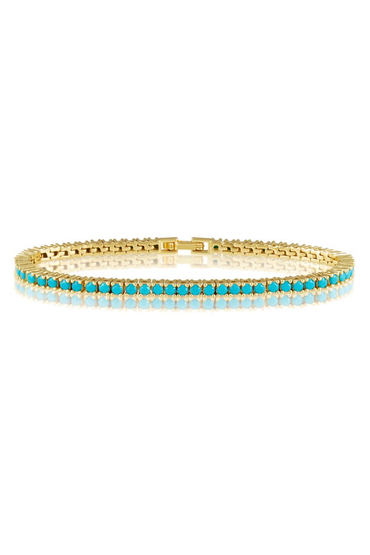 Gold bracelet with turquoise stones on a white background