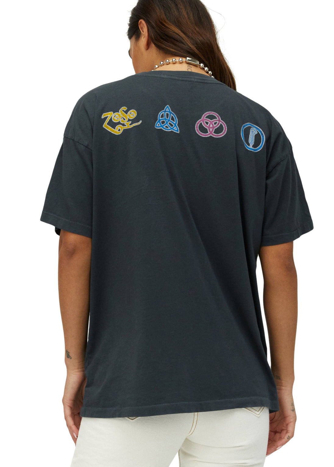 Person wearing a black t-shirt with colorful symbols on the back