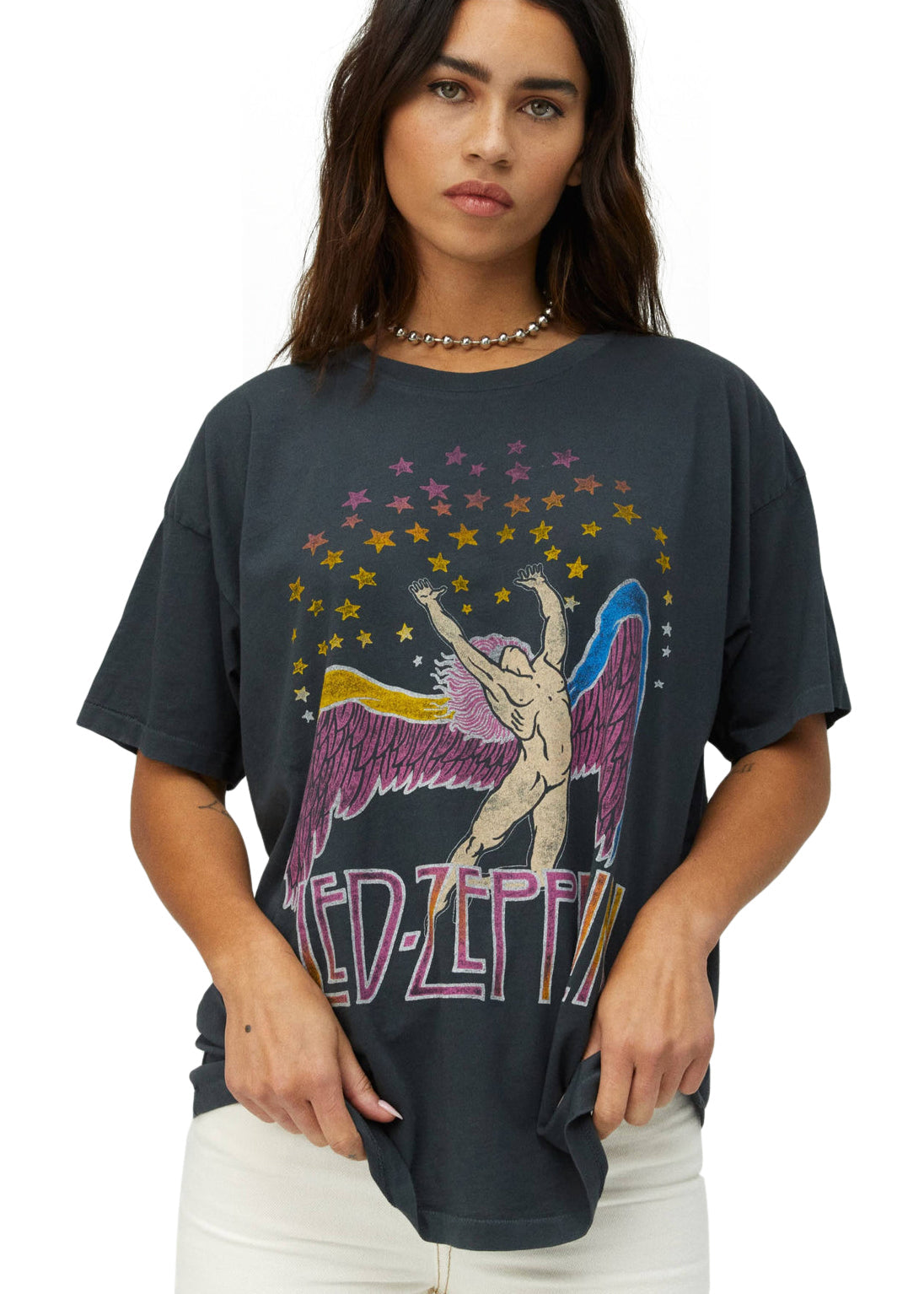 Person wearing a black t-shirt with a colorful graphic design on a white background