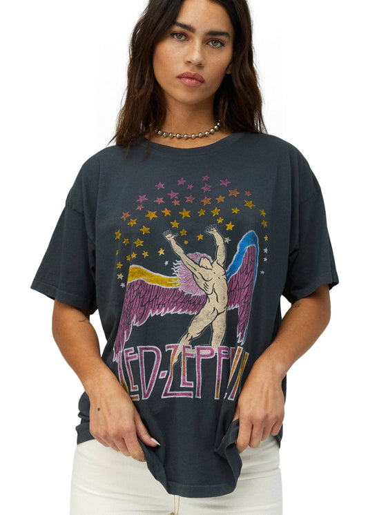 Person wearing a black t-shirt with a colorful graphic design on a white background