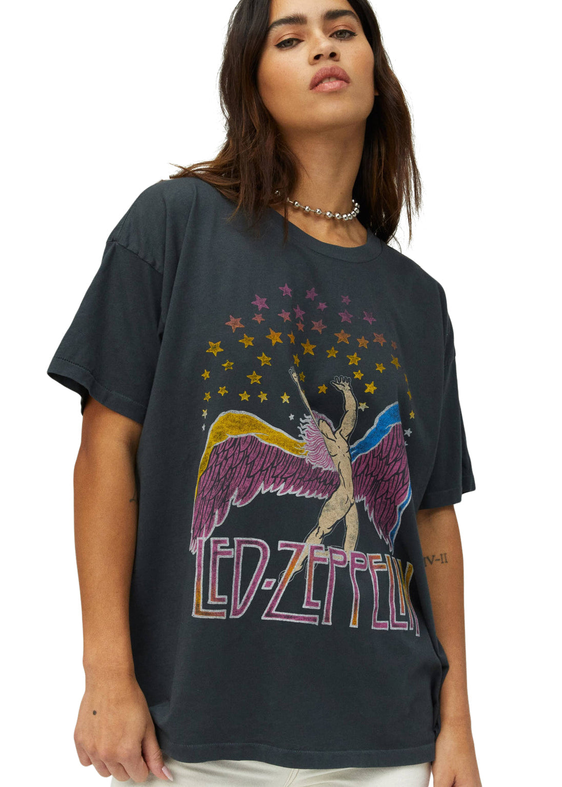 Person wearing a black t-shirt with a colorful 'Led Zeppelin' graphic design.