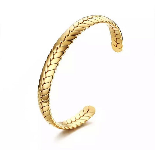 Gold braided bracelet on a white background