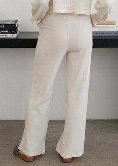 Person wearing beige pants with a blurred background